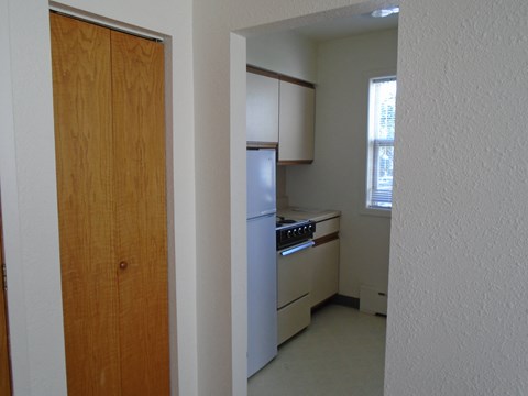 a view of a kitchen from the doorway of an empty room